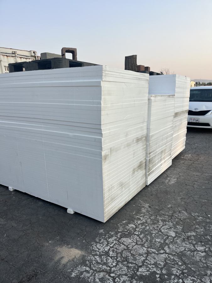 Stacked white EPS foam blocks in the yard at sunset