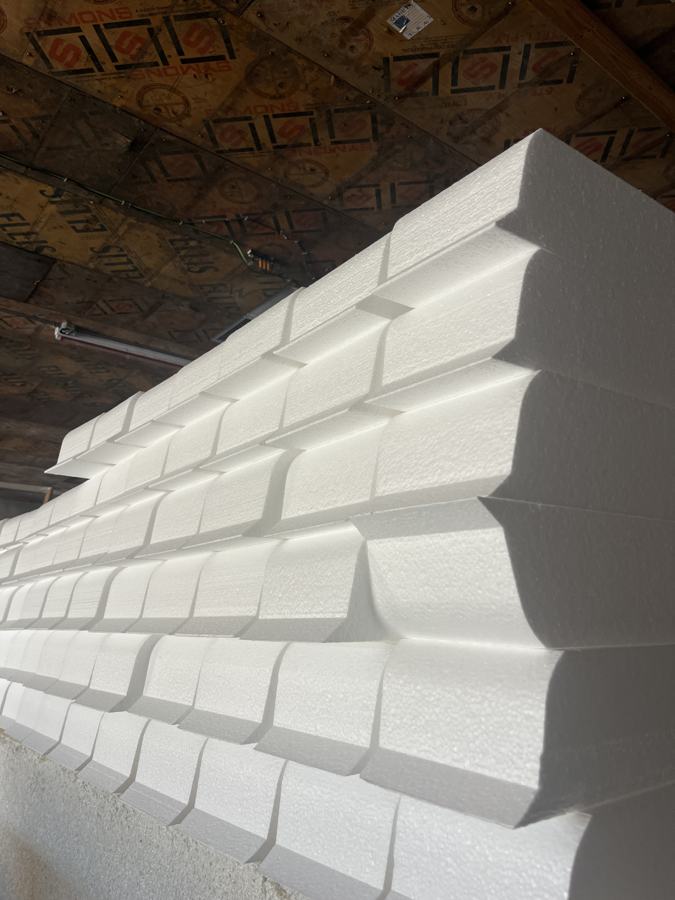 Stack of CNC-cut white EPS stepped profiles